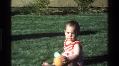 California USA (1977): Baby Crawling Outside Grass Bushes Romper Yellow Ball