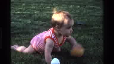 California USA (1977): Cute Little Baby Crawling In The Grass Outside During The