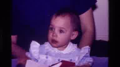 California USA (1977): Baby Opens Present With Dad