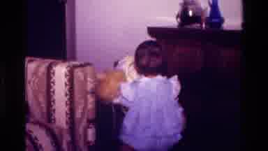 California USA-1977: Little Girl Holding Stuffed Bear Walks and Smiles