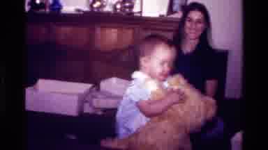 California USA (1977): A Little Baby Girl Enjoying Her Bear At Her Birthday Party