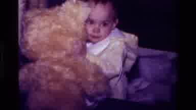 California USA (1977): Young Baby Boy Trots Around Carrying A Large Golden Teddy