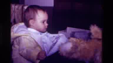 California USA (1977): Happy Young Baby Opening Present During Birthday Event With