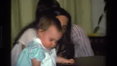 California USA (1977): A Female Adult With A Baby In A Living Room