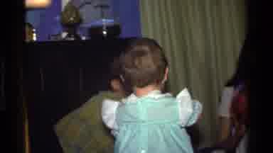 California USA (1977): Baby Excitedly Clapping As She Wobbles To Adults