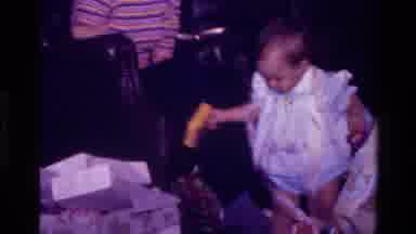 California USA (1977): Young Excited Child Is Feverishly Tearing Open Their Gifts
