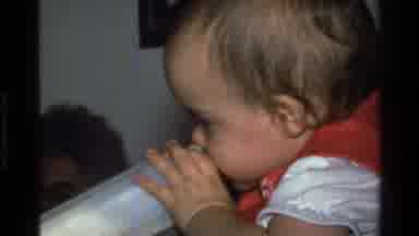 California USA (1977): A Toddler With A Bottle Of Milk And Then Sitting On A