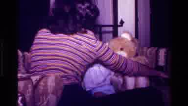 California USA (1977): Mother Taking Care Of Her Baby In The Home Playing With