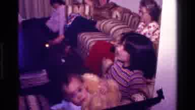 California USA (1977): Kid In Hallway Walking Down Turning Around While The Family