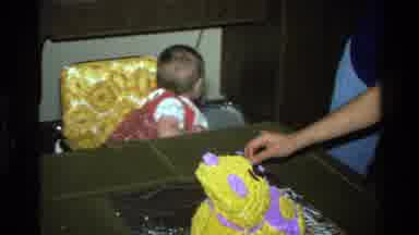 California USA (1977): Toddler Sitting On A Yellow Chair Impatiently Waiting To