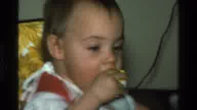 California USA (1977): Baby Eating Food And Getting It All Over Their Little Face