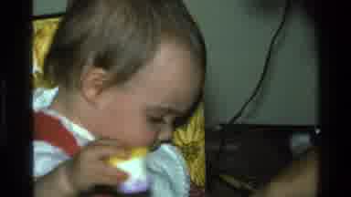 California USA (1977): Contented Toddler Being Fed And Focusing On The Process