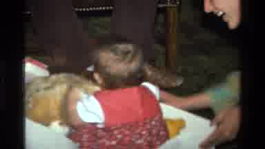 California USA (1977): Baby And Teddy Bear Going For A Ride In A Box