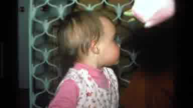 California USA (1977): Little Baby Girl Wearing A Pink And White Dress Looking And