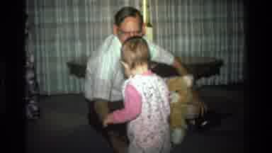 California USA (1977): A Little Baby Girl Playing With Toys With Her Father