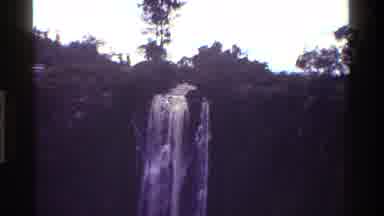 Kenya (1983): Water Rapidly Flows Down Waterfall Rocks Into Darkly Shaded Basin