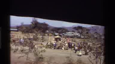 Kenya (1983): People Gathered Walking Around Near Large Arched Metal Roofed