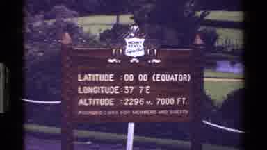 Kenya (1983): An Albino Peacock Shows Plumage And Wooden Sign Displays Park