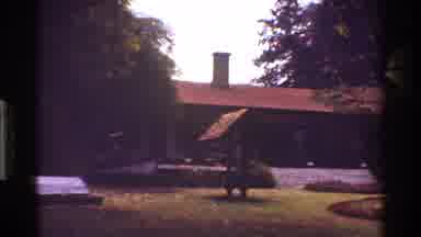 Kenya (1983): Shot Of Front Face Of A Building And The Surrounding Grass And Trees