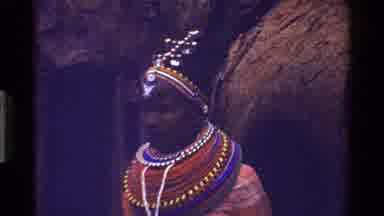Kenya (1983): African Lady Dressed In Ornate Traditional Outfit Followed By Three