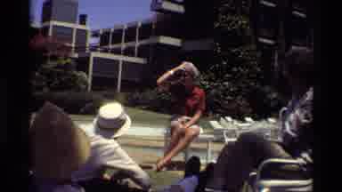 Kilaguni Kenya (1983): People Gather Outside Apartment Building To Listen To Woman