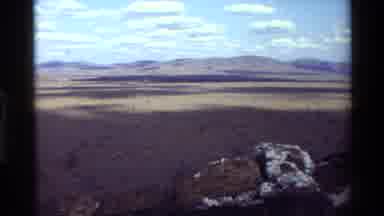 Kilaguni Kenya (1983): A Man With Binoculars Scans A Desert Valley From A Mountain