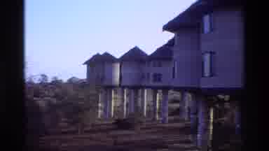 Kilaguni Kenya (1983): Elephants Drinking From A River Near Raised Homes
