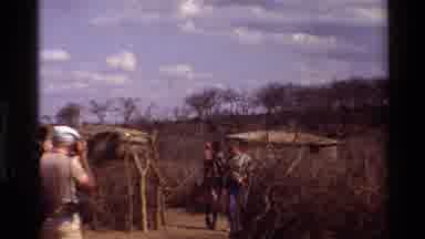 KILAGUNI KENYA-1983: Maasai Women Welcoming White Tourists in Rural Village