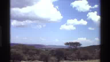 Mara Tanzania (1983): Blue Skies Lush Greenery With Small Building Which Does Not