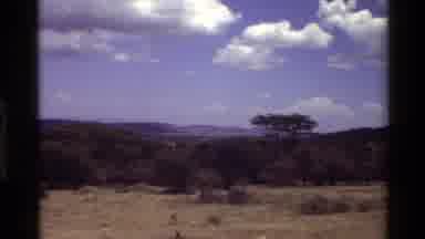 Mara Tanzania (1983): A View Of Mountain Peaks And Thick Clouds In The Sky