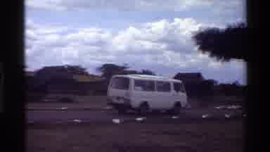 Mara Tanzania (1983): White Van Slowing Down On Curvy Road To Go Over A High Speed