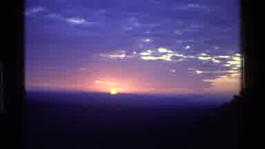 Mara Tanzania (1983): Distant Warm Sun Sets On The Horizon On A Mid Cloudy Evening