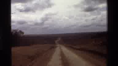 Mara Tanzania (1983): Driving On A Bumpy Dirt Road In The Wilderness Toward A