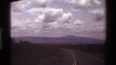 Mara Tanzania (1983): A Long Two Lane Road Through Trees And Flat Land Towards A