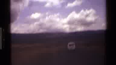Mara Tanzania (1983): A Vast Landscape With Mountain In The Distance And Some