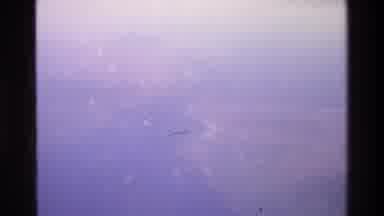Singapore (1984): Aeroplane Window Shots Of Ground And See Below Including Plane