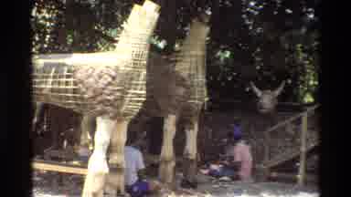 Singapore (1984): Two Large Wooden Four Legged Creatures Are Being Made By A Crew