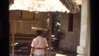 Singapore (1984): One Woman Is Walking And Some Men Are Sitting By Reading