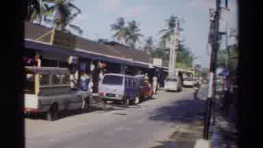 Singapore (1984): An Old Lady Entering A Crowded Restaurant While A Motorcycle