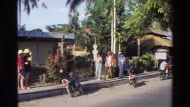 Singapore (1984): Man Walking With Black Object On Head On Bright Sunny Day