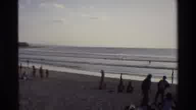 Singapore (1984): People On The Beach And Playing In The Surf As The Waves Come In