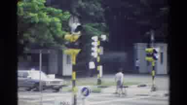 Singapore (1984): Man Walking Through A Crosswalk And A Set Of Skyscrapers Viewed