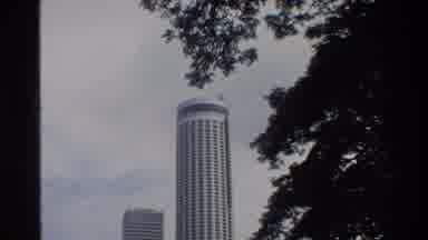 Singapore (1984): Skyscraper And A Big Building With Columns Surrounded By A Park