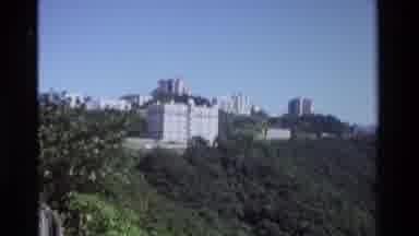 Hong Kong (1984): Light-Colored Buildings Overlook Densely Vegetated Hillside