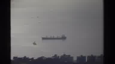 Hong Kong (1984): Camera Zooms Into A Freight Boat On The Ocean With Cinematic