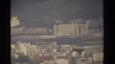 Hong Kong (1984): Aerial View Of City And Sea Port On A Cloudy Day