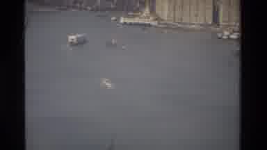 Hong Kong (1984): Two Large Cargo Boats Sailing Away From The City Shore