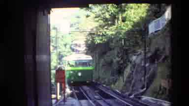 Hong Kong (1984): Green Train Car Slowly Moves Forward Along The Old Railroad