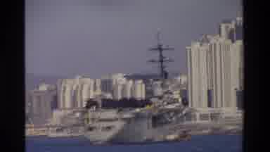 Hong Kong (1984): Different Sized Ships And Boats On The Water With Cityscape In