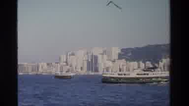 Hong Kong (1984): Daytime City Skyline Next To The Water With Boats And Mountains